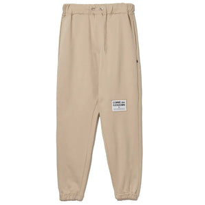 Comme Des Fuckdown Chic Pantalón deportivo de algodón beige con detalles deshilachados