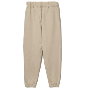 Comme Des Fuckdown Chic Pantalón deportivo de algodón beige con detalles deshilachados