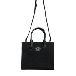 Versace Bolso tote cruzado con logo de cuero y lona con asa superior negra